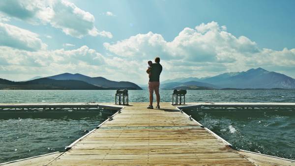 dad and kid on a dock