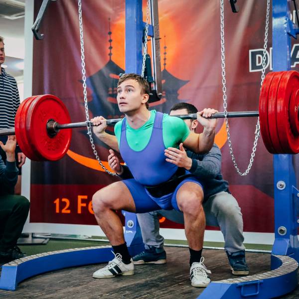 A competitor at a powerlifting meet doing a squat