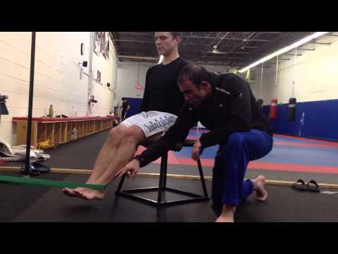 Video: BreakingMuscle.com: Hip Mobility - How to Do Banded Leg Curls (Sam Spiegelman)