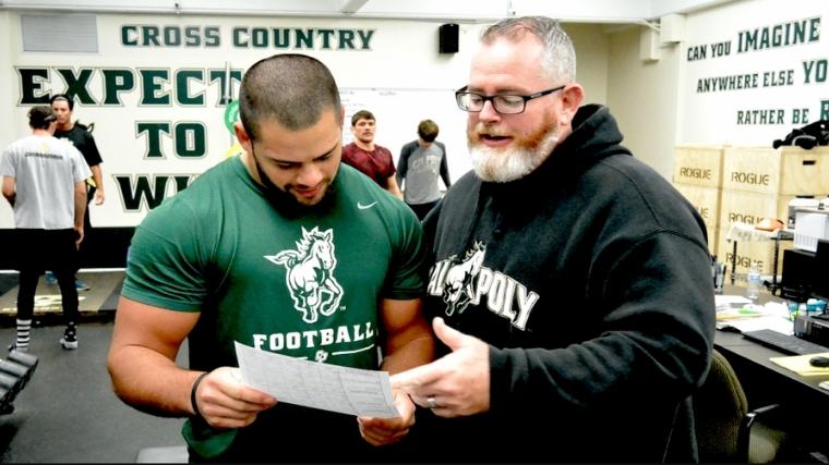 Coach Chris Holder explains his program to the athlete