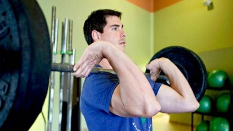 A man carrying a full-length barbell