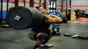 Guilherme hang cleans during a workout.