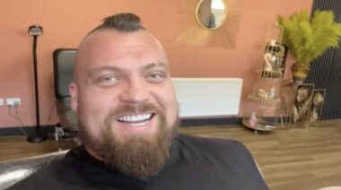 Eddie Hall smiles after a getting tattoo of Hafthor Bjornsson in April 2022