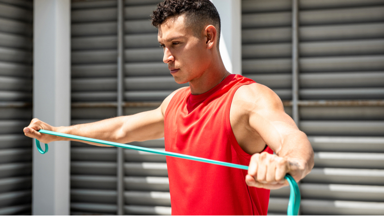 Man performing resistance band pull apart exercise