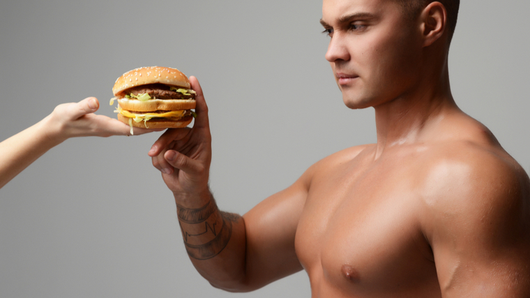 Man refusing to eat fast food burger being offered