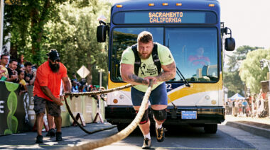 Strongman pulling bus