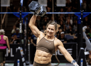 Tia-Clair Toomey smiling while holding a dumbbell in hand