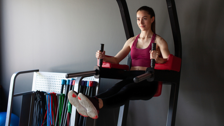 Woman in gym performing leg raise