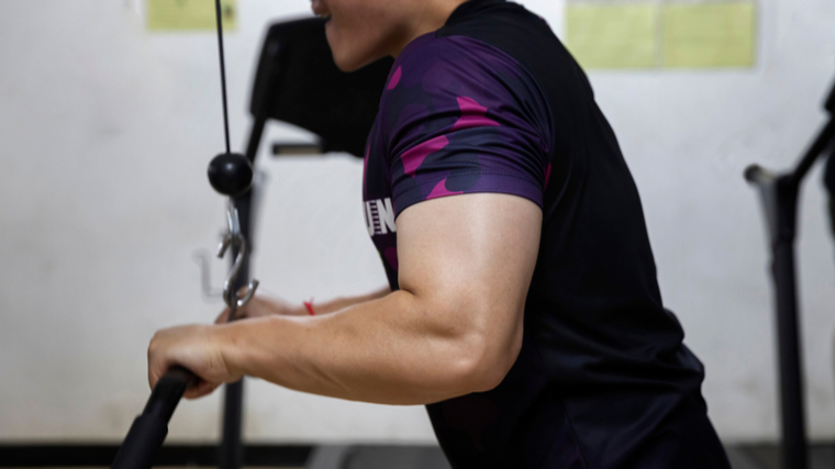 close-up of person wearing t-shirt performing triceps cable exercise