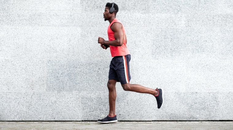 People running outdoors near concrete wall