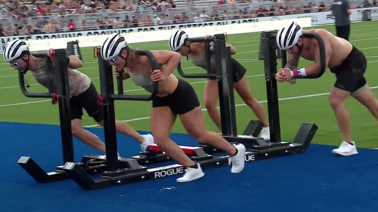 crossfit games team pushing weighted sled