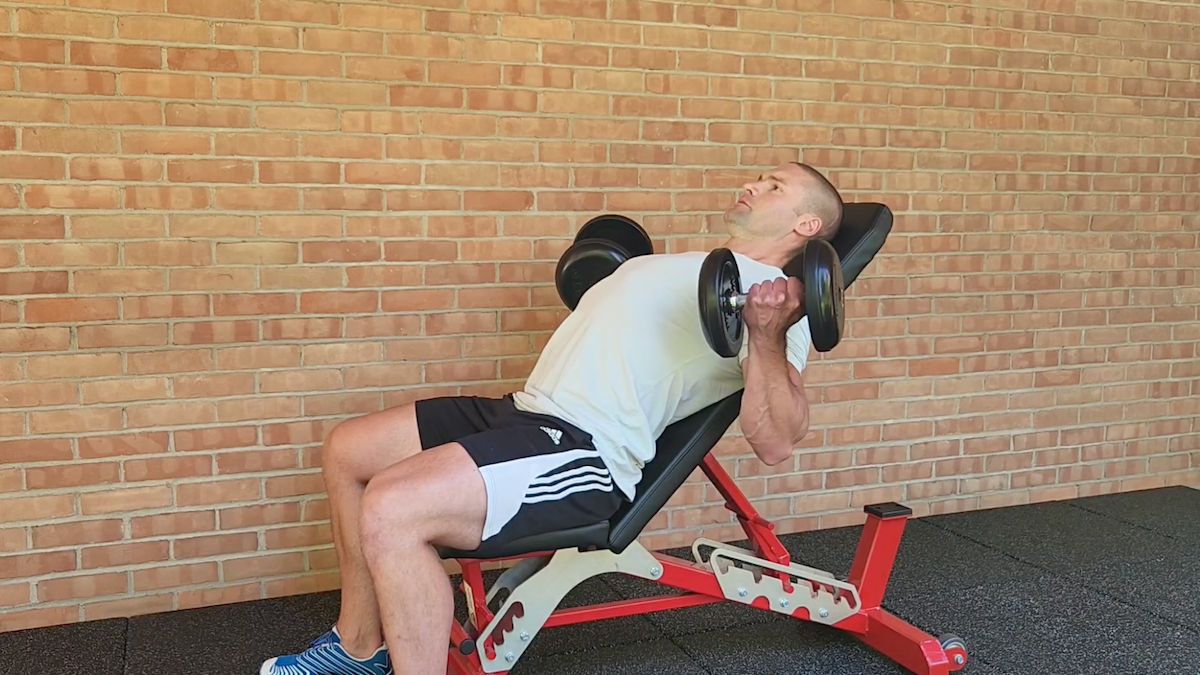 person performing incline dumbbell curl