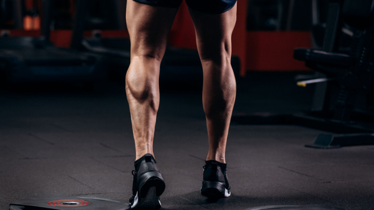 person flexing muscular calves