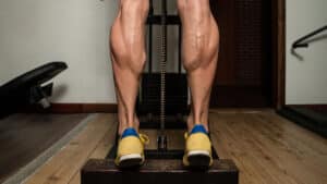 muscular calves performing calf raise exercise