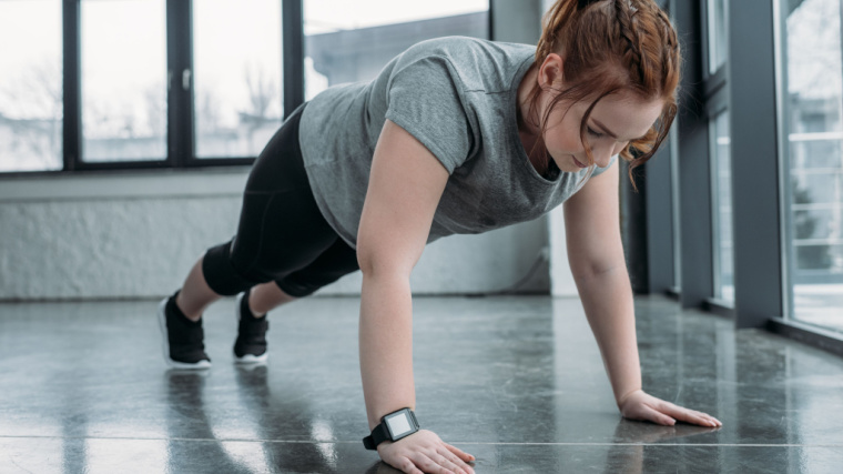 red-haired person doing push-ups
