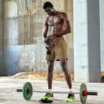 muscular person lifting weights outdoors