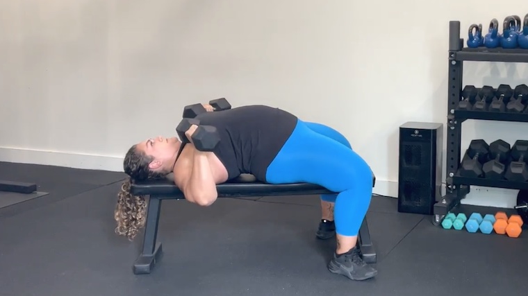person doing flat dumbbell bench press