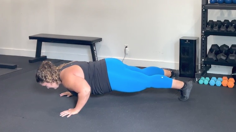 person doing push-up on gym floor