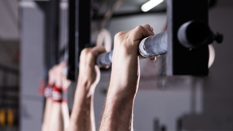 close-up view of hands gripping pull-up bar