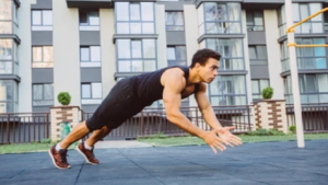 person outdoors performing explosive push-up