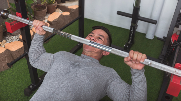 muscular person in gym doing bodyweight row