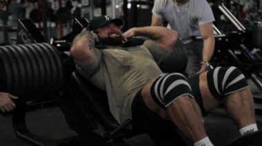 bodybuilder Chris Bumstead straining on squat machine