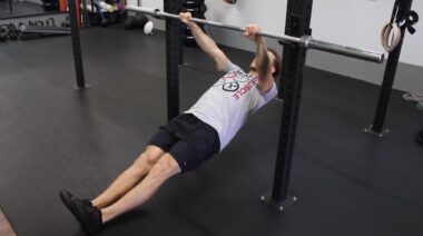 Person in gym doing bodyweight row