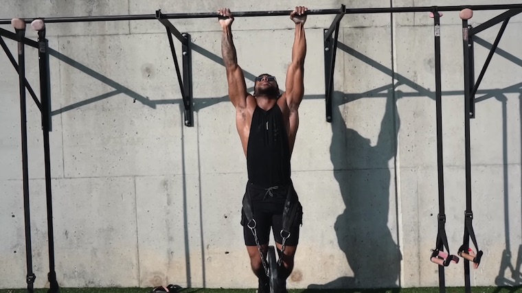 person doing pull-ups outdoors