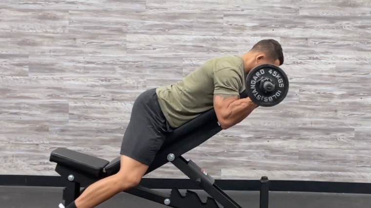 person on seat curling barbell