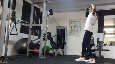 Person in gym doing cable exercise