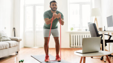 Person in living room exercising with resistance band