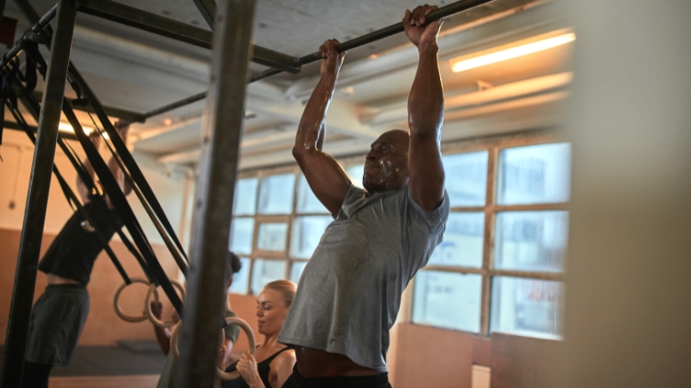 A person doing a pull up.