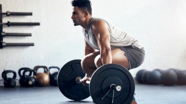 A person starting to do a deadlift.