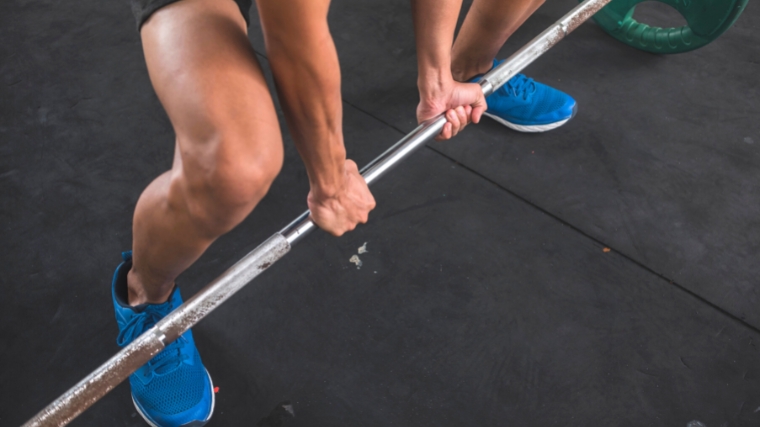 A lifter using a mixed grip to lift the barbell