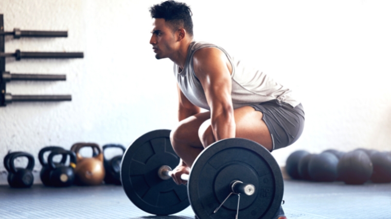 A weightlifter doing a deadlift in the gym.