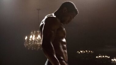 Actor Jonathan Majors with muscular bodybuilding physique.