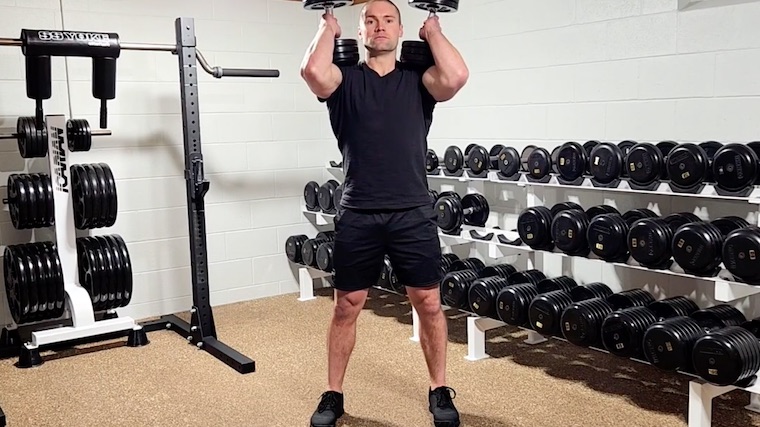 Dr. Merrick Lincoln in gym standing with dumbbells