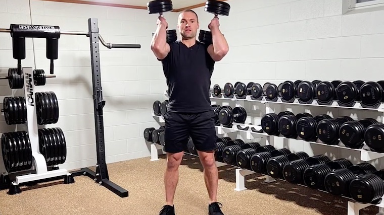 Dr. Merrick Lincoln in gym doing dumbbell clean