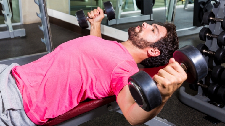 A person doing a dumbbell flye.