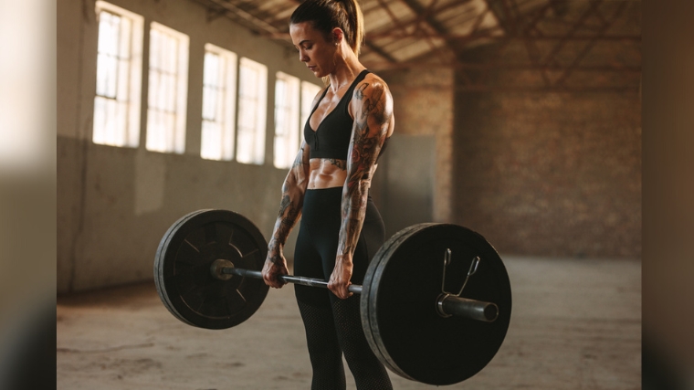 A person preparing for a reverse biceps curl.