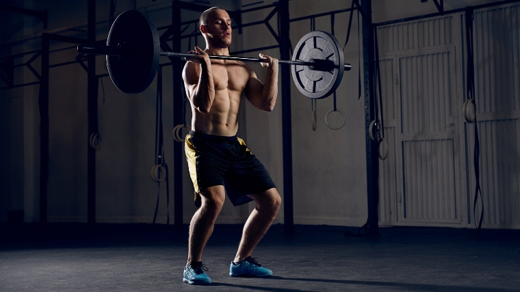 A person dipping during a clean & jerk.