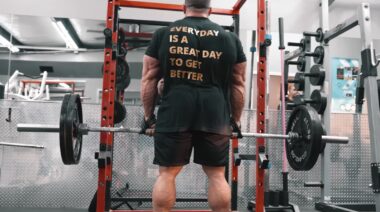 Bodybuilder Derek Lunsford in gym holding barbell