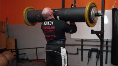 Strongman Oleksii Novikov performing overhead log lift