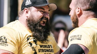 Muscular strongman competitors in contest