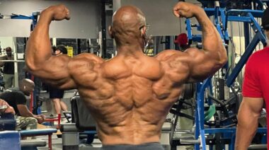 Bodybuilder Fred Smalls flexing back and arm muscles