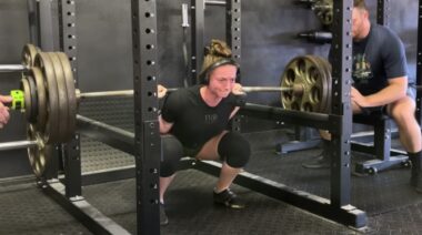 Powerlifter Natalie Richards in gym performing heavy squat