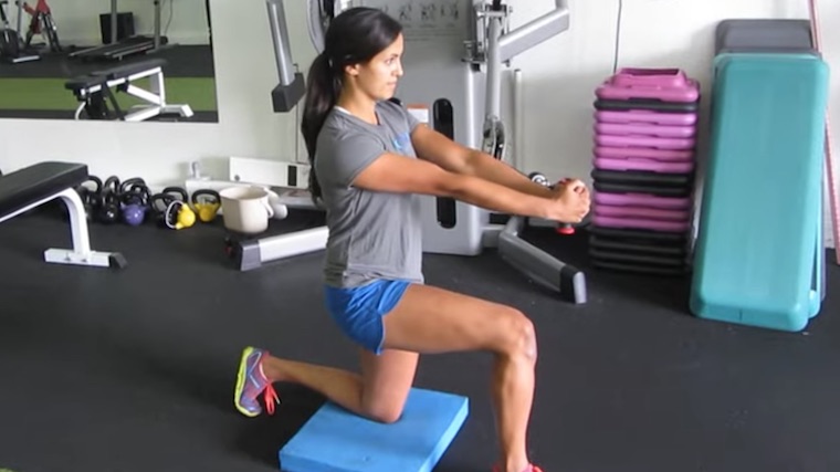 long-haired person in gym performing core exercise with cable