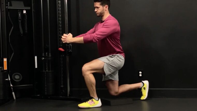 Coach James Shapiro demonstrating half-kneeling split squat Pallof press