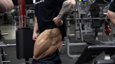 Bodybuilder Iain Valliere flexing leg muscles