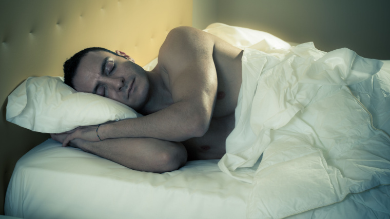 Muscular person in bed asleep